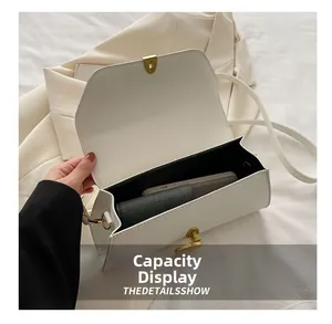 Vue détaillée de l'intérieur spacieux du sac baguette blanc avec fermoir doré