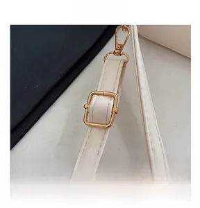Adjustable beige PU leather shoulder strap with polished gold-tone metal buckle detail