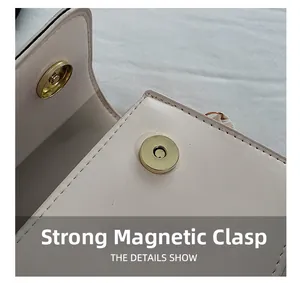 Detailed macro view of the strong magnetic buckle on a vintage light pink leather handbag