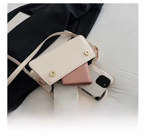 Interior view of cream white small flap bag showing capacity for phone and wallet