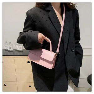 Chic pink rectangular crossbody bag shown with structured handle and slim strap for women