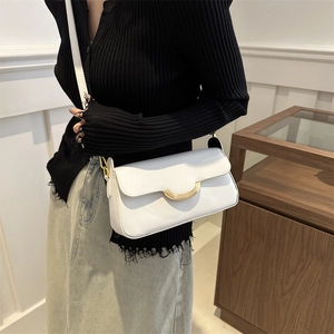 Minimalist white PU leather crossbody bag with golden half-moon buckle worn by a model