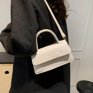 Chic beige square flap underarm bag in matte leather shown with shoulder strap