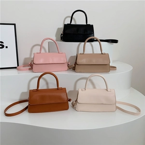 Chic vintage style faux leather underarm bags in five neutral colors displayed on pedestals