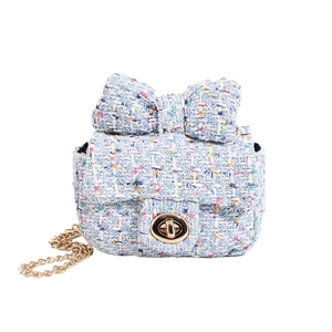 Tweed crossbody bag with large bow and gold chain strap in light blue finish