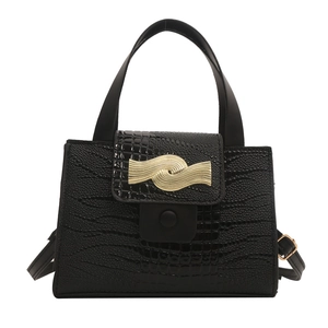 Elegant black stone textured top-handle bag with a gold metal buckle on a white background