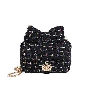 Chic tweed crossbody bag with colorful patterns, gold chain, and oversized bow detail