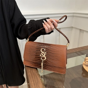 Brown crocodile pattern shoulder bag with gold hardware and tassel detail for women