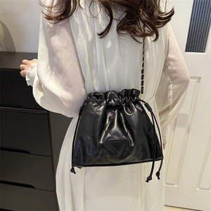 Fashionable black quilted drawstring bucket bag with elegant chain shoulder strap for women