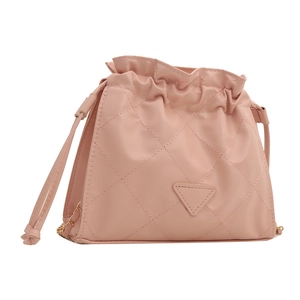 Pink quilted drawstring bucket bag with triangular leather patch and metal chain strap