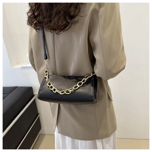 Fashionable black faux leather shoulder bag featuring a bold gold chunky chain detail