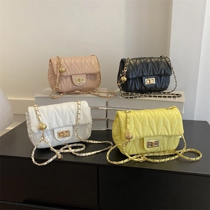 Quilted saddle bags in pink, black, white, and yellow with metal chain straps