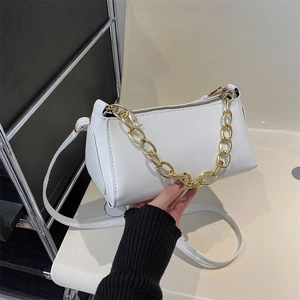 White baguette bag with gold chain and PU leather shoulder strap in a hand-held view