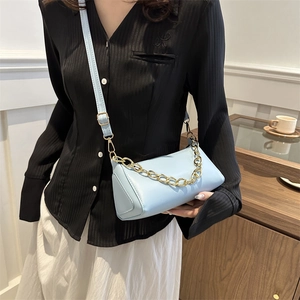 Minimalist light blue cylindrical crossbody bag with gold chain strap for women
