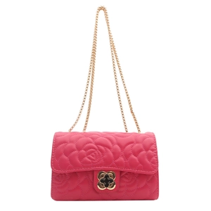 Magenta quilted crossbody bag with floral clasp and gold chain strap on white background