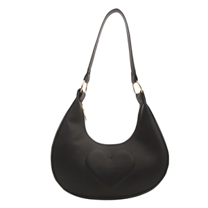 Minimalist black hobo shoulder bag with embossed heart pattern and gold hardware accents