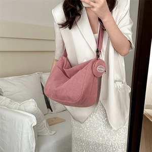 Pink corduroy large capacity hobo bag with round coin purse shown in a mirror selfie style