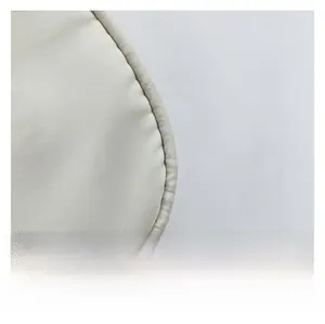 Detailed macro view showing twill fabric texture and clean stitching of the shoulder bag