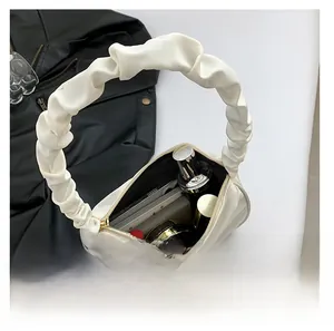 Interior view showing large capacity for phone, cosmetics, and perfume in white puffy bag
