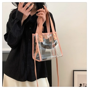 Detail view of pink PVC jelly tote bag featuring gold rivets and detachable shoulder strap