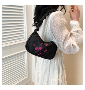 Detail of nylon hobo bag with pink butterfly prints and a scrunchie shoulder strap