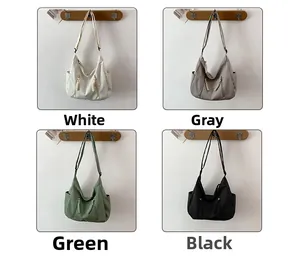Detail view of four casual canvas crossbody bags showing white grey green and black colors