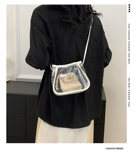 Detail of transparent PVC crossbody bag with white trim and beige canvas inner pouch