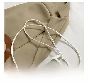 Detail showing the adjustable white strap and fixed buckle on a clear PVC jelly bag
