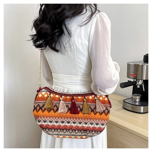 Close-up of bohemian woven bag featuring colorful geometric patterns and stylish tassels