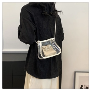 Detailed shot of transparent PVC tote bag with beige linen drawstring inner pouch