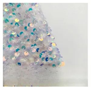 Detailed macro view of purple plush fabric with iridescent sequins on a stylish bag