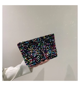 Close-up of vibrant rainbow sequin clutch bag for parties and special events