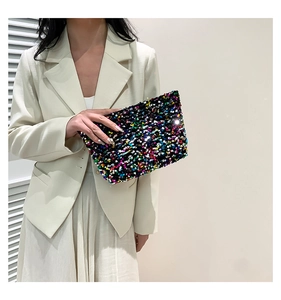 Detail of colorful sequined clutch bag showing vibrant light-reflecting textures