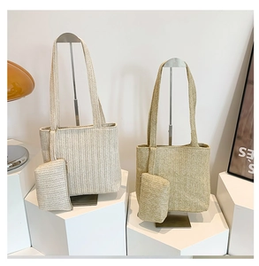 Close-up of woven straw tote bag with inner pouch and herringbone texture detail
