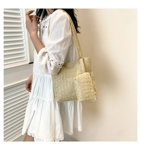 Detail of woven straw tote bag and mini pouch in herringbone pattern for summer style