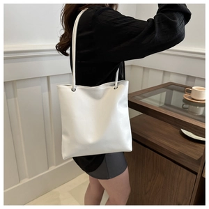 Minimalist white PU leather tote bag shown on model for elegant daily commuting style