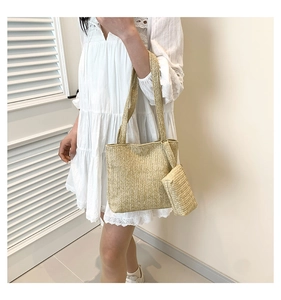 Close-up of khaki woven tote bag showing fine herringbone texture and small pouch