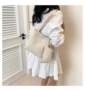 Detail of cream straw woven tote bag set with matching coin purse for summer travel