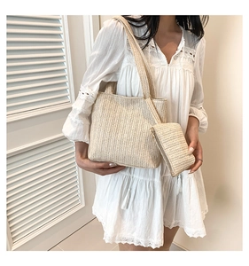 Detail of straw woven tote with matching zipper pouch and fishbone texture pattern