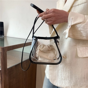 Minimalist transparent PVC tote bag with black leather trim and drawstring inner pouch