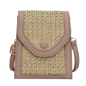 Fashionable woven straw crossbody bag with nude pink leather trim and adjustable strap