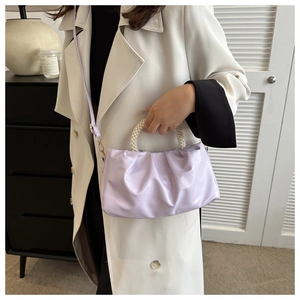 Light purple pleated cloud bag featuring pearl beaded handle and sleek crossbody strap