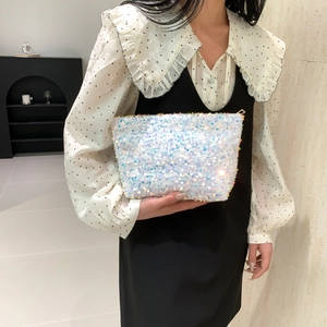 Chic sequined clutch and makeup bag with iridescent white sequins for fashion styling