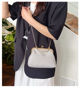 Detailed macro view of the sparkling silver rhinestone clutch with golden chain strap