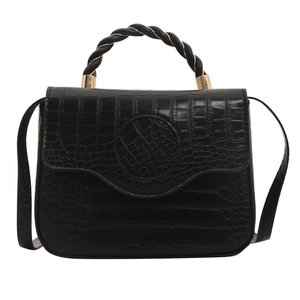 Fashionable black crocodile pattern handbag with twisted handle and gold hardware detail