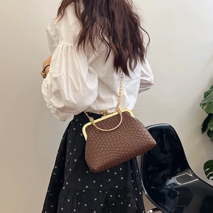 Brown woven texture doctor bag with gold clasp and chain strap, shown on a model