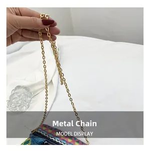 Detail of colorful ethnic crossbody bag with gold chain strap and stylish blue tassel