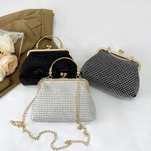 Elegant rhinestone shell crossbody bag with metal chain and vintage handle in silver
