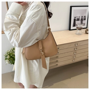 Chic light brown underarm bag with metal hook detail and minimal leather design