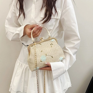 Straw woven crossbody bag with blue floral embroidery and golden metal handles